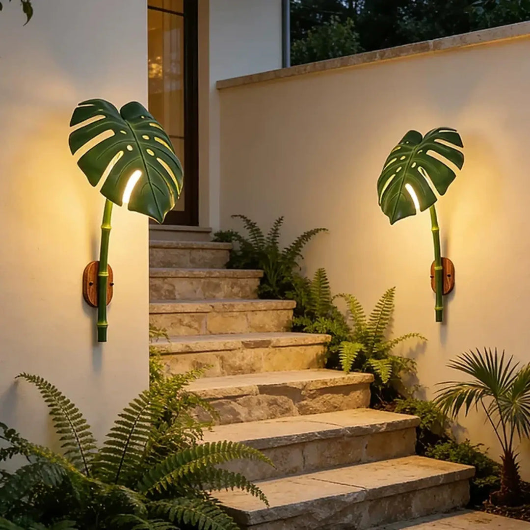 Luminaire extérieur leavah wall lamp green monstera leaf shape with bamboo stem accents and warm wooden backplates