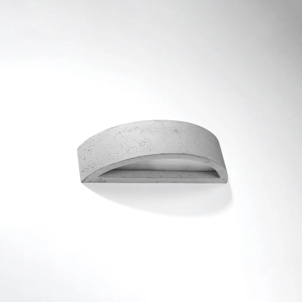 Applique murale atena en béton avec design minimaliste courbé créant une atmosphère harmonieuse pour agencements industriels