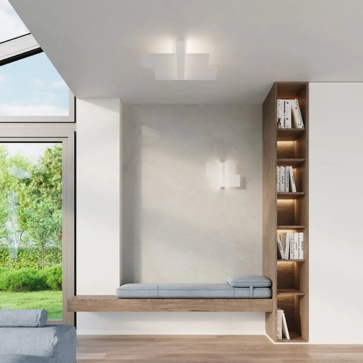 Banc capitonné gris clair avec cadre en bois et bibliothèque intégrée blanc met magnifiquement design intemporel