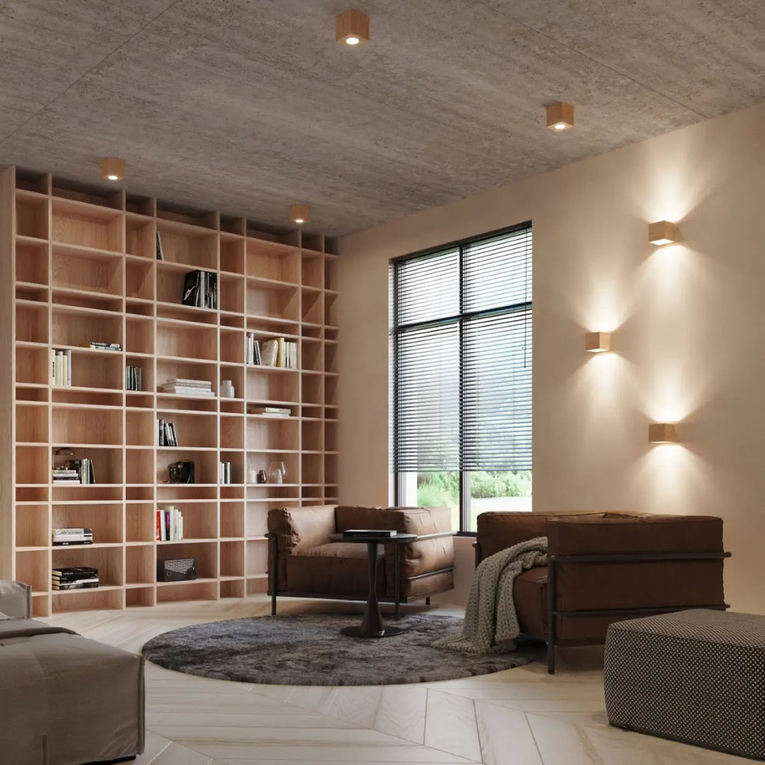 Brown leather armchairs with metal frames and a textured throw blanket complementing applique murale quad bois naturel for une ambiance chaleureuse montées individuellement