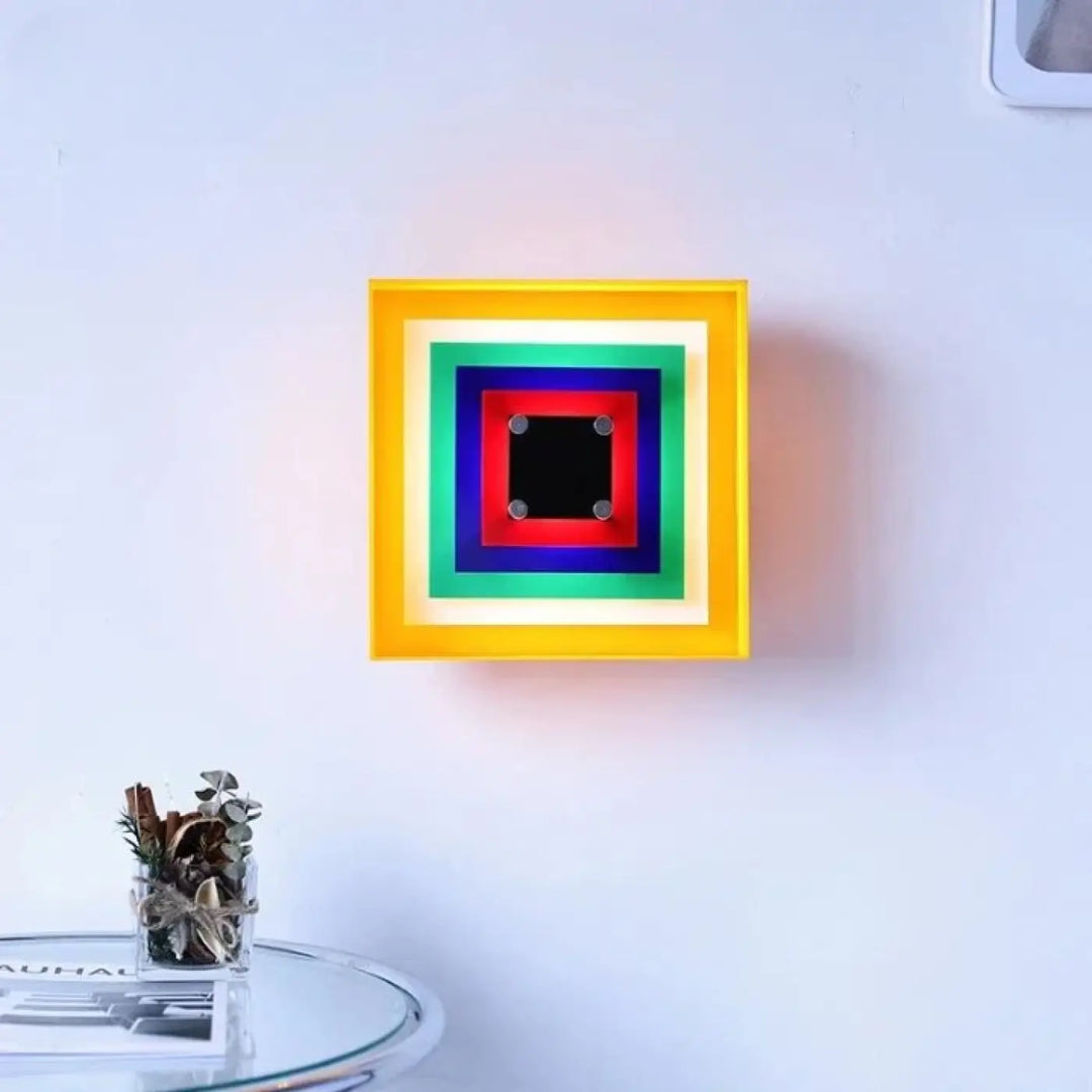 Applique murale vivao carrée avec cadres concentriques multicolores et panneau central noir pour murale design