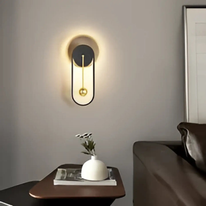 Applique murale dorano design minimaliste noir et or avec halo lumineux ovale allongé pour ambiance chaleureuse