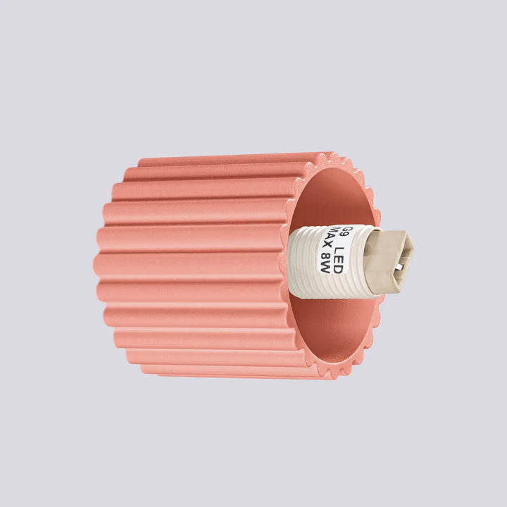 Applique murale halo en plastique ondulé rose avec base beige et étiquette blanche idéale pour bureau décorative