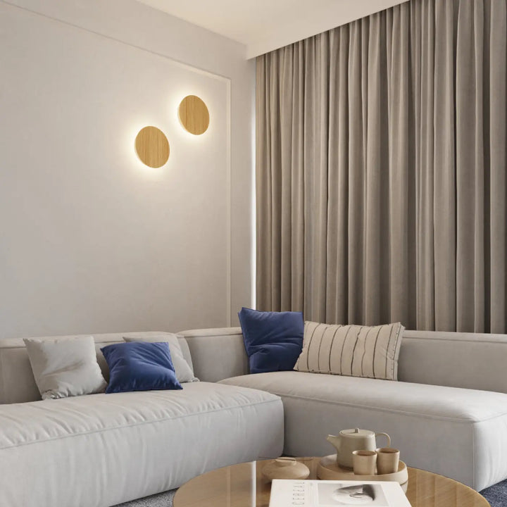 Beige linen curtains with vertical pleats hang beside modern sectional sofa featuring applique murale borgens 3000k wood
