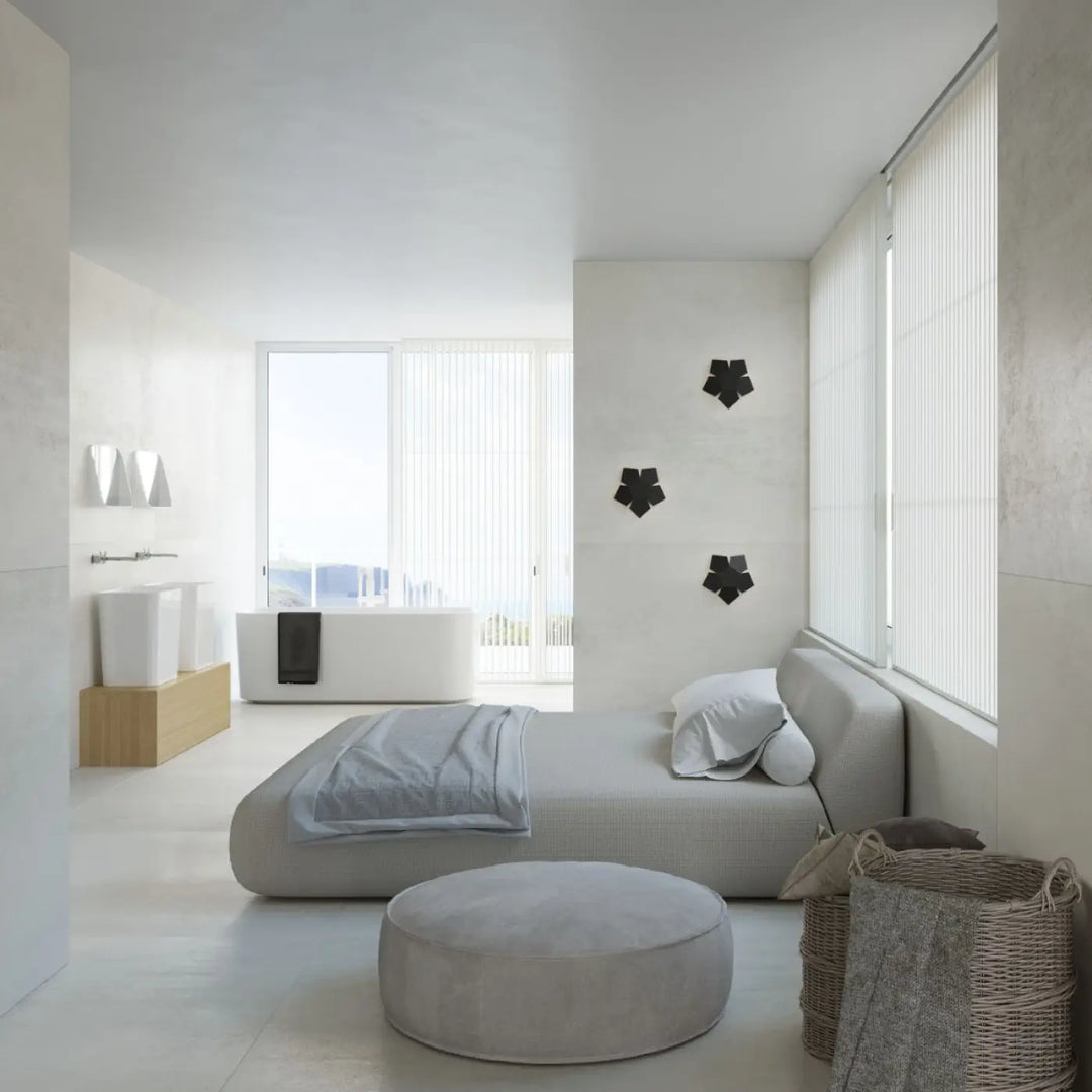 Gray upholstered daybed with matching round ottoman featured with applique murale penta noir, klasyczny kinkiet szczególnie do nowoczesnych wnętrz