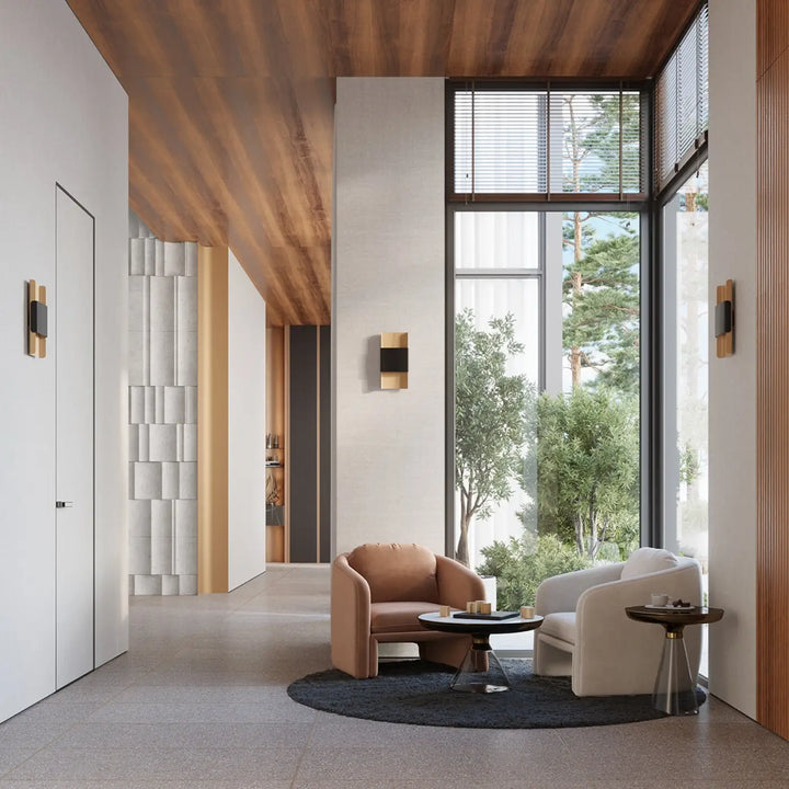 Fauteuil en cuir tan avec dossier arrondi et assise moelleuse à côté d un fauteuil blanc dans un espace moderne minimalisme rencontre applique durlin
