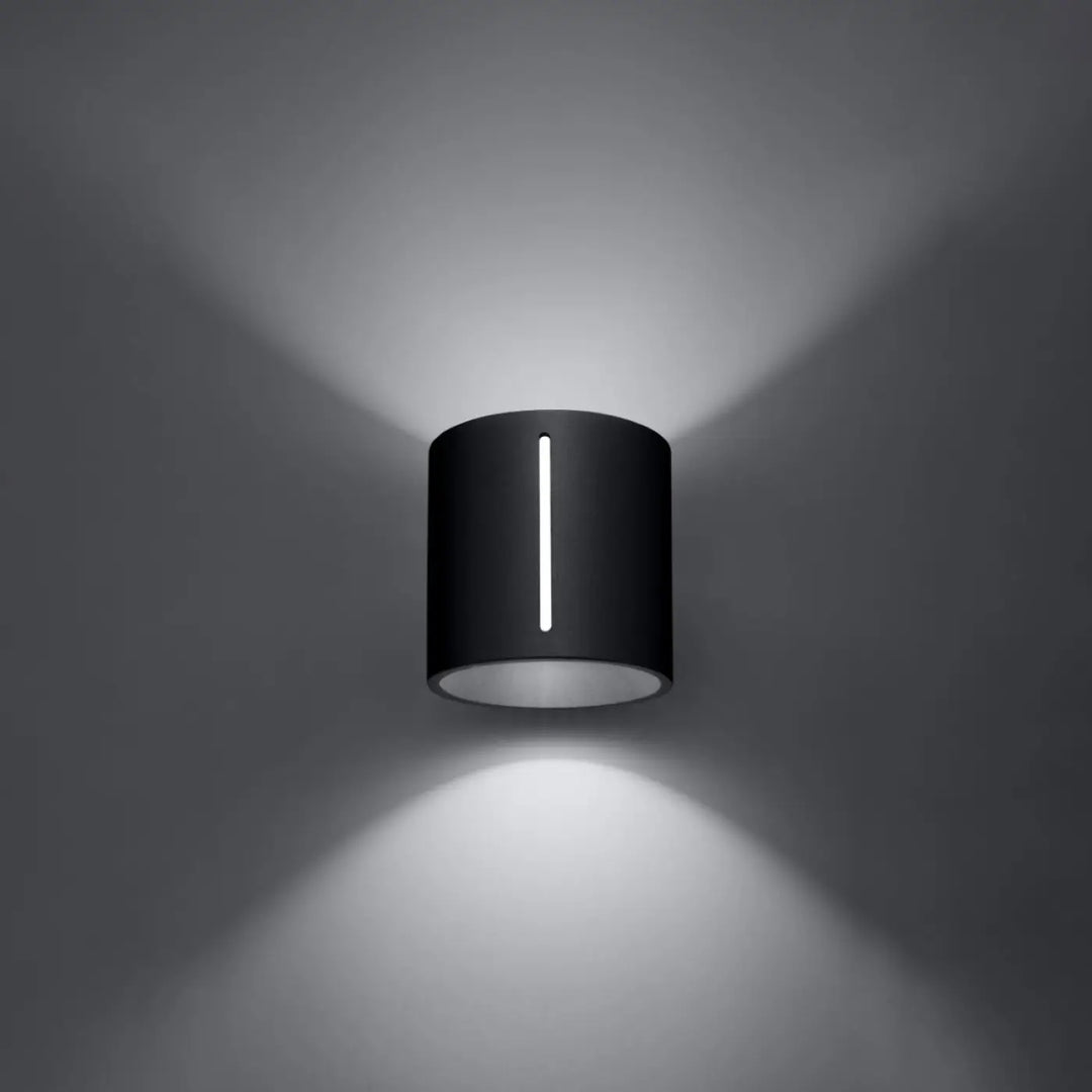Murale inez applique murale moderne noire cylindrique avec perforation linéaire et led directionnelle lumineuse