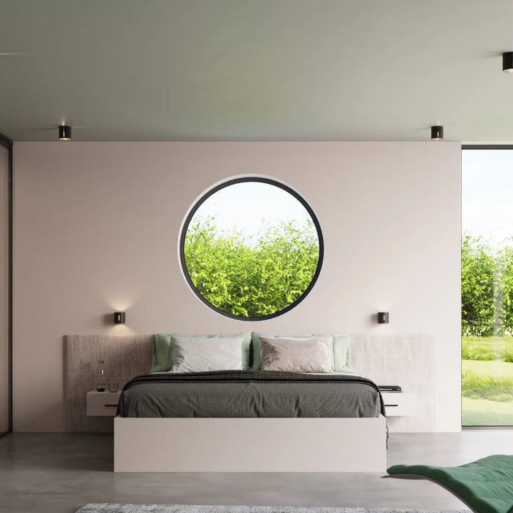Applique murale inez noir featuring a circular window with perforation linéaire set on a pale pink wall