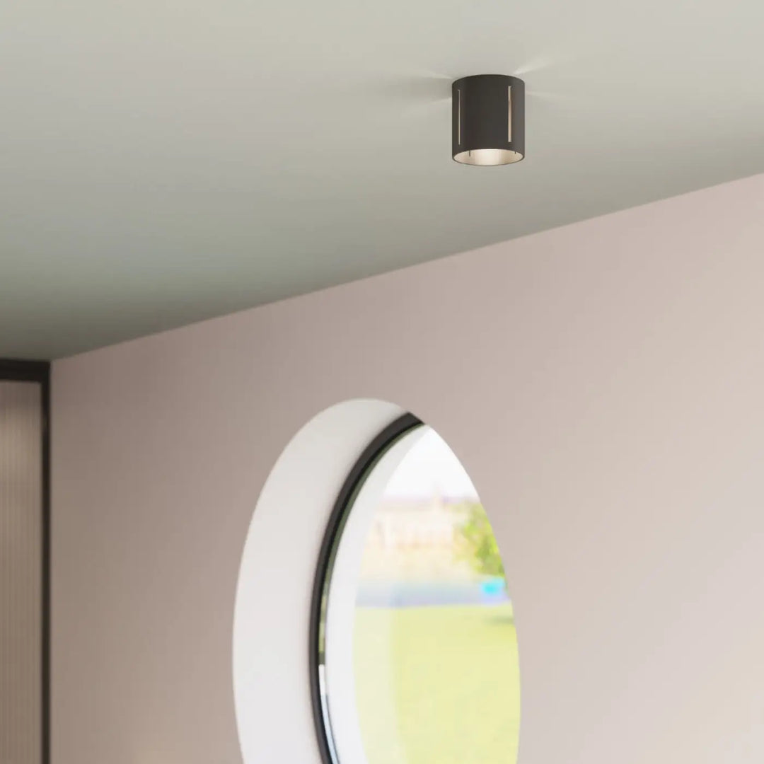 Applique murale moderne inez noir cylindrique avec perforation linéaire et design minimaliste pour éclairage intérieur