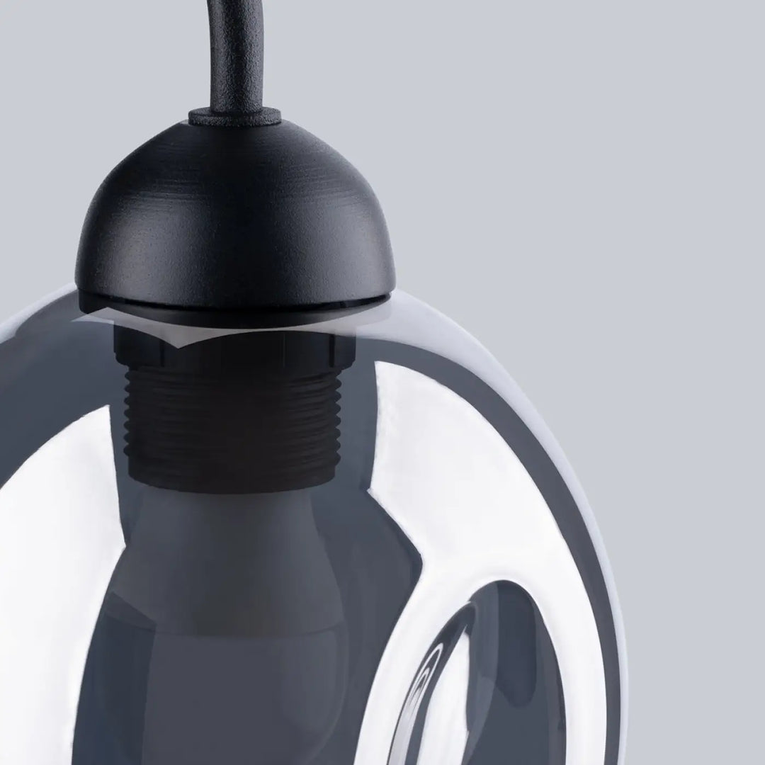 Black pendant light with matte finish and sleek spherical glass globe resembling l’applique fillan noir