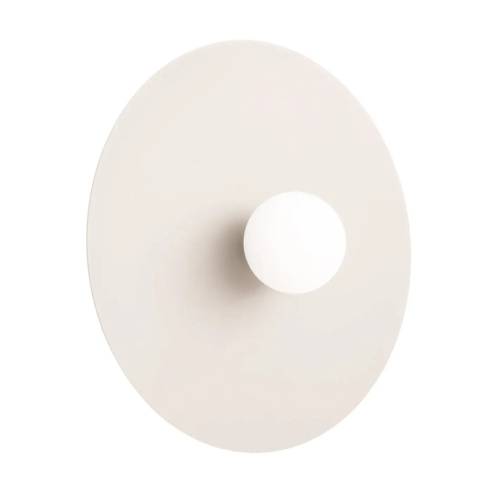 L’applique murale ake 50 beige présente un disque métallique rond avec une sphère laiteuse centrale minimaliste