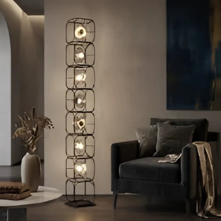 Lampadaire luxora design vertical en métal noir avec diffuseurs lumineux en verre, esprit artistique et lumière chaude