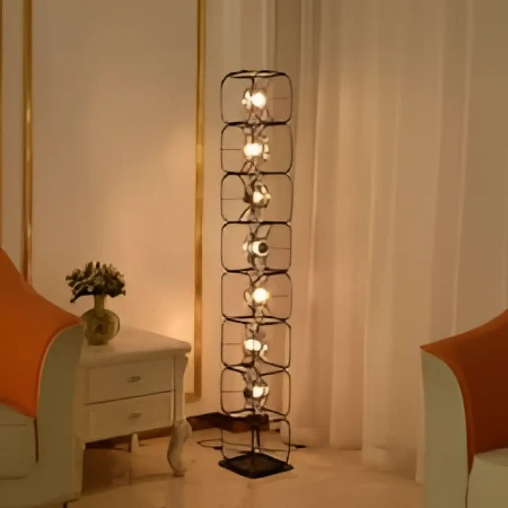 Lampadaire design vertical noir en fer forgé avec plusieurs diffuseurs lumineux esprit artistique luxora