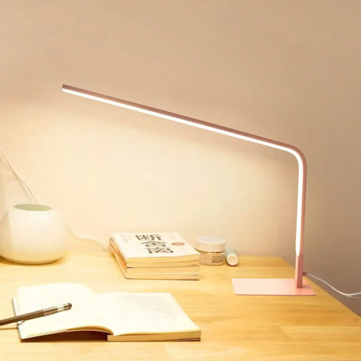 Lampe de table led contemporaine en rose gold avec design minimaliste et bras fin incurvé marque minini