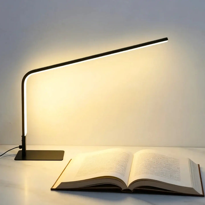 Lampe led contemporaine noire minini avec design minimaliste courbé et éclairage ambiant chaleureux