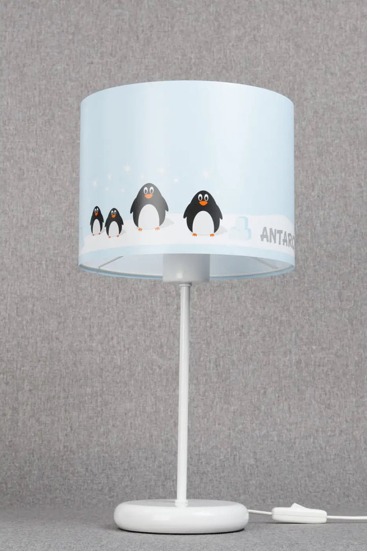 Lampe de table sweet dreams bleu clair avec abat-jour cylindre aux adorables manchots et pied blanc arrondi