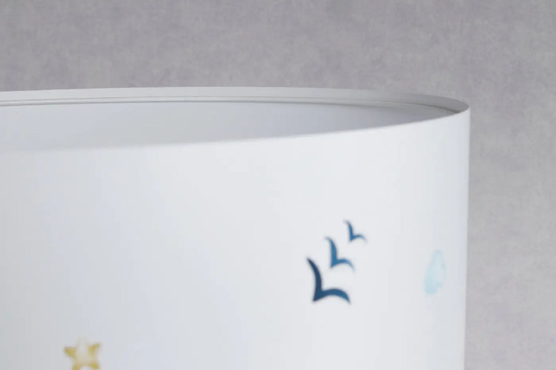 Lampe de table blanche avec abat-jour cylindrique décor oiseaux bleus subtils et étoiles dorées pour nuages rêvés