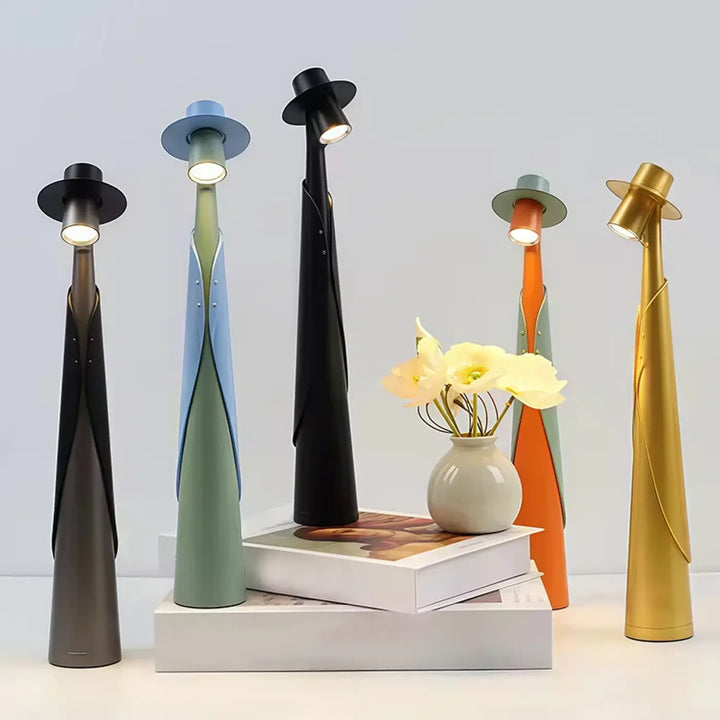 Lampe de table dandy avec cinq figures stylisées en finition métallique mate noir olive or bronze et orange