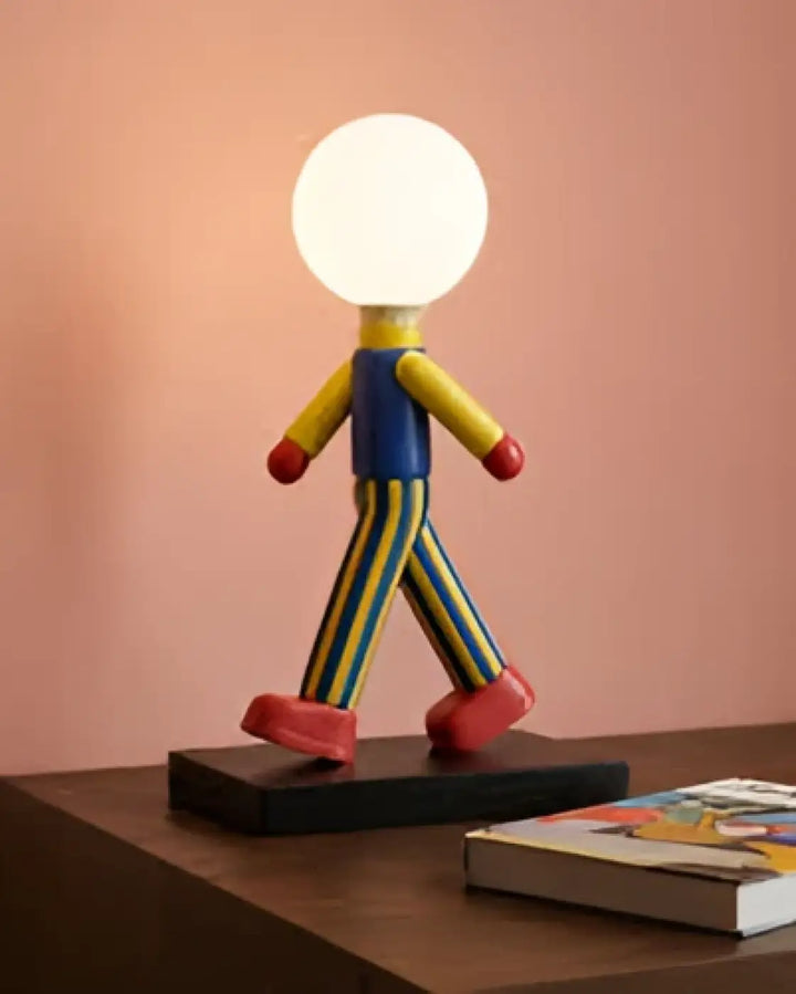 Lampe de table luzio figurine colorée avec globe lumineux blanc et torse rayé vert et jaune sur base noire design table