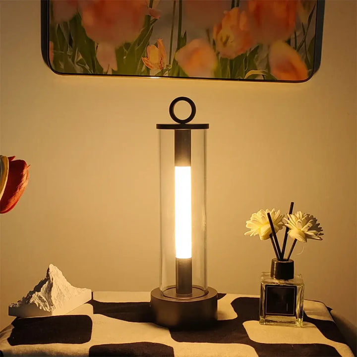 Lampe de table tiber avec tube lumineux clair en verre, base et anneau noir, finition élégante pour table moderne