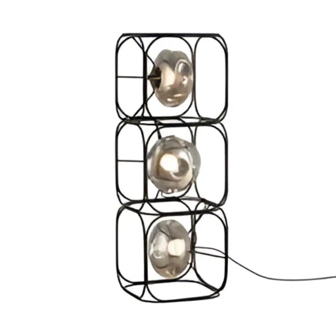 Lampe de table haloza en cube metal noir avec trois sphères lumineuses en verre empilées pour un table design sculptural