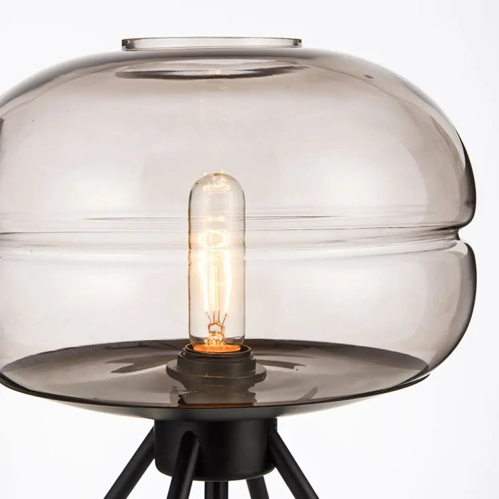 Lampe de table grisa avec verre fumé et design minimaliste sur pieds tripodes noirs pour un cadeau original