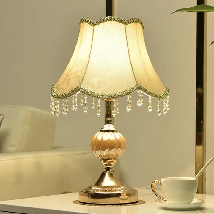 Lampe de table Debhy en métal doré avec abat-jour crème à festons et pampilles en cristal pour décoration intérieure vintage chic