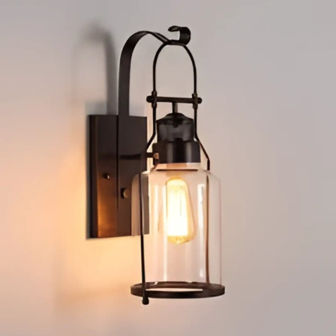 Luminaire extérieur orsina en fer forgé noir avec design raffiné et ampoule à filament visible sous verre transparent