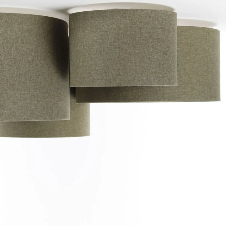 Luminaire plafonnier with four olive-green fabric lampshades featuring a natural textured woven appearance