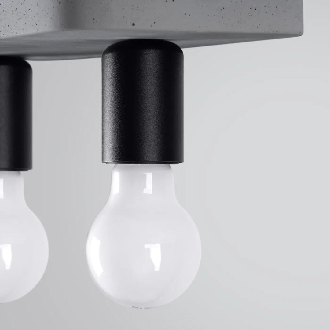 Plafonnier tavo gris béton avec porte-lampe cylindrique noir et ampoule en verre clair pour ambiance unique et esthétique moderne
