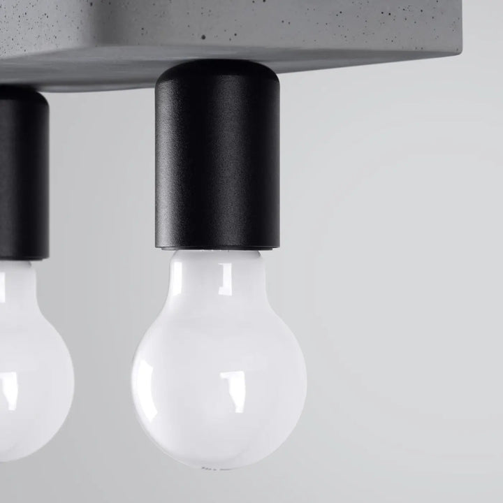 Plafonnier tavo gris béton avec porte-lampe cylindrique noir et ampoule en verre clair pour ambiance unique et esthétique moderne
