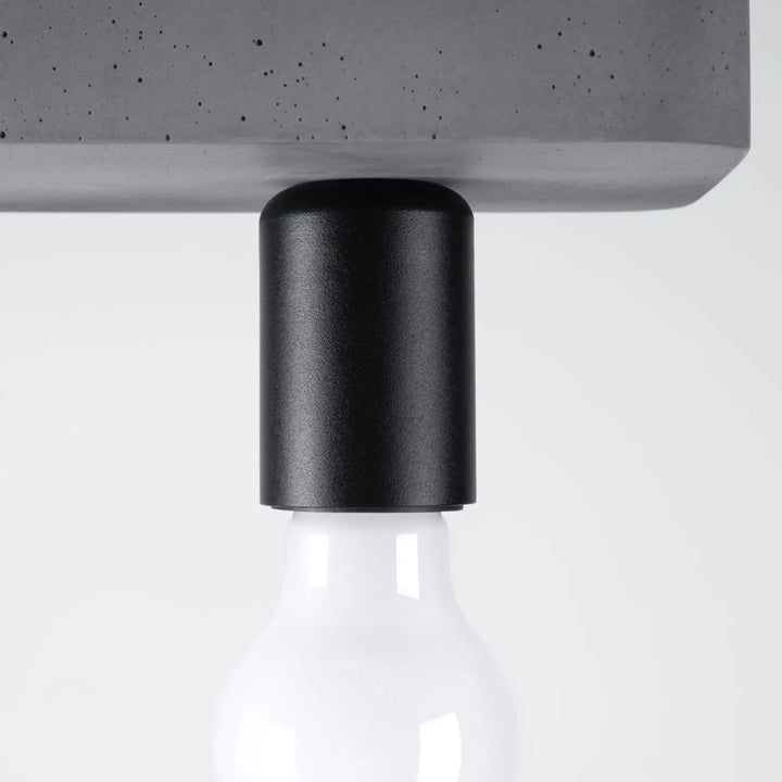 Plafonnier tavo en gris béton avec support cylindrique noir mat reliant une ampoule en verre pour une esthétique moderne et une ambiance unique