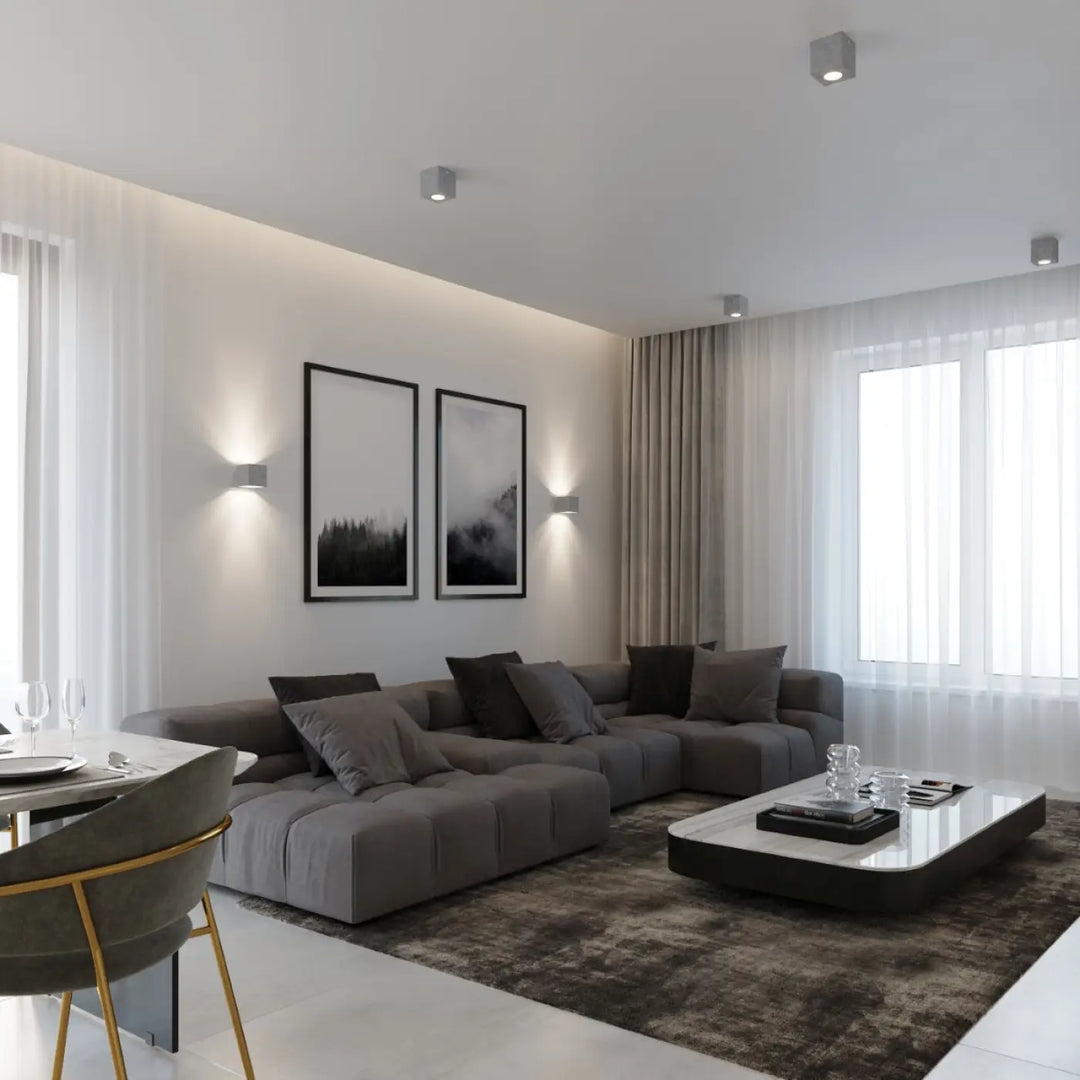 Gray modular sectional sofa with tufted cushions and dark gray throw pillows in luminaire plafonnier quad béton gris béton