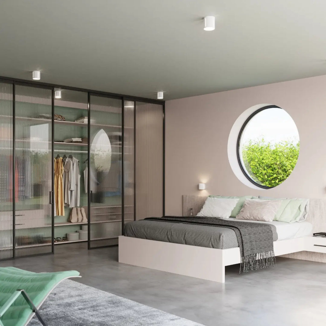 Modern white platform bed with gray textured bedding and light green accent pillows under a plafonnier inez spectacle lumineux forme géométrique