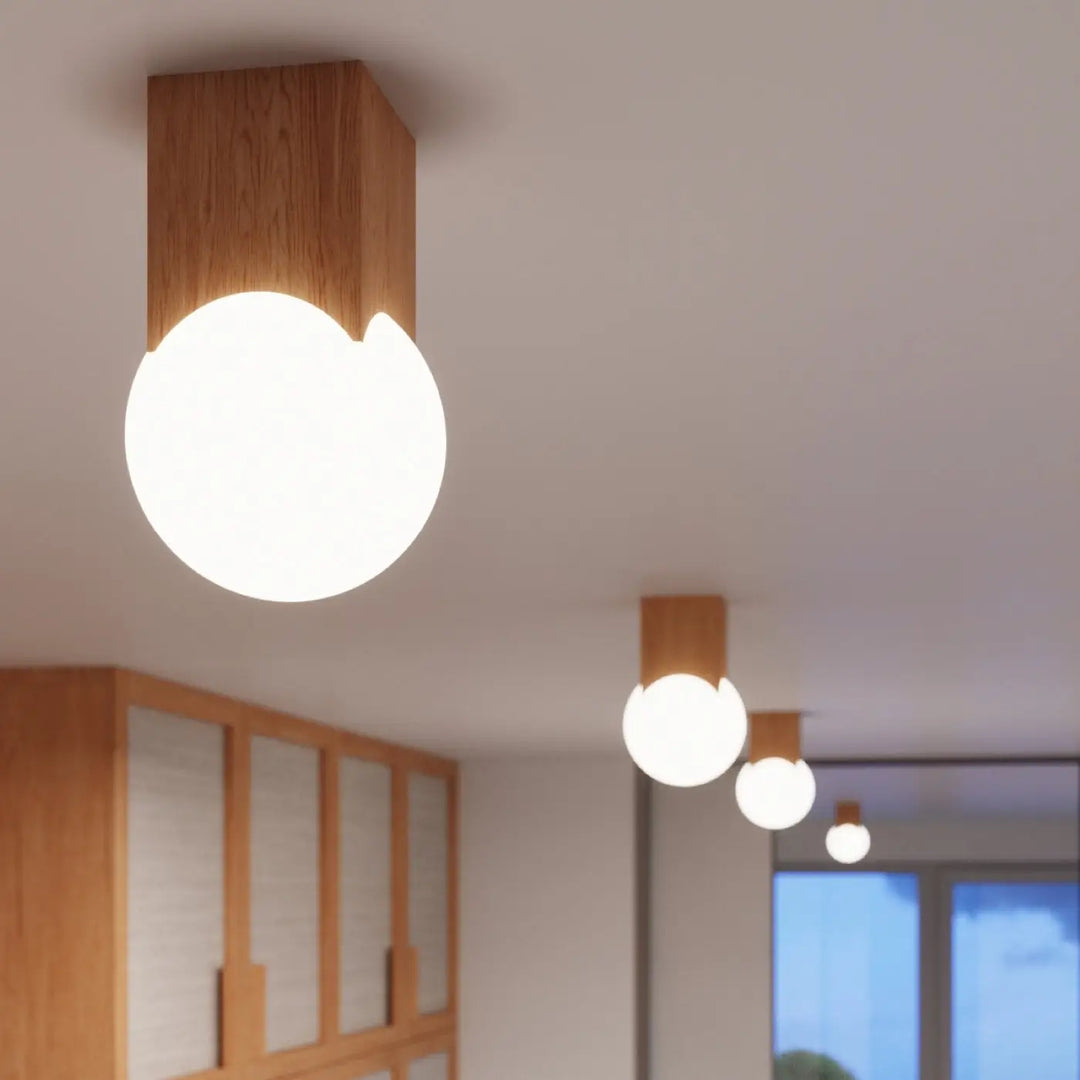 Luminaire plafond solis en bois naturel avec une lampe solis design minimaliste et un abat-jour sphérique crée en verre dépoli