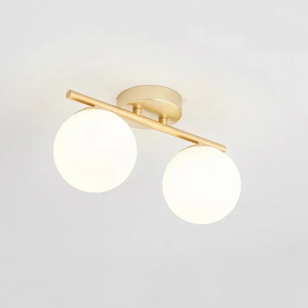 Luminaire plafonnier moderne en boules blanches avec support doré