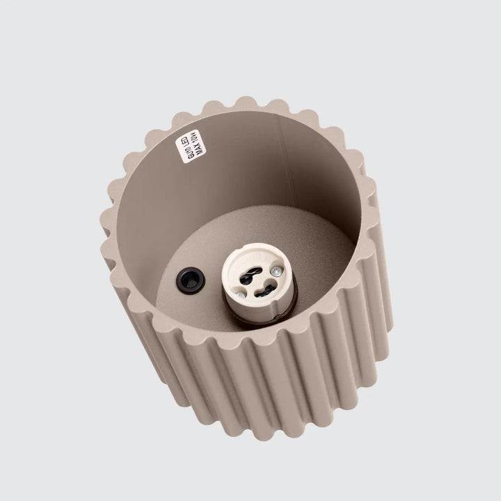 Beige ribbed plastic lamp socket with white ceramic base and black terminal in luminaire plafonnier aura 1 taupe forme unique inspirée