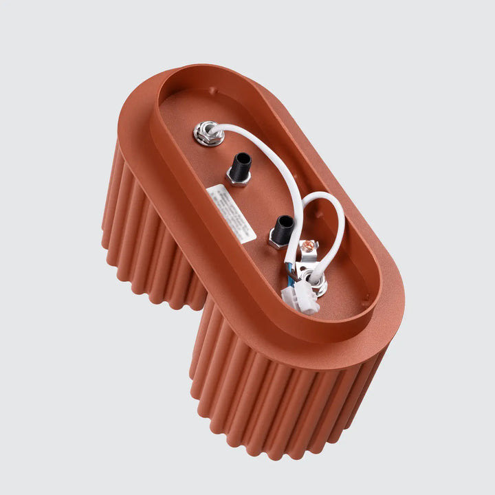 Luminaire plafonnier aura 2 rouge ochra en forme unique inspirée avec corps ovale cannelé terracotta et composants électriques apparents