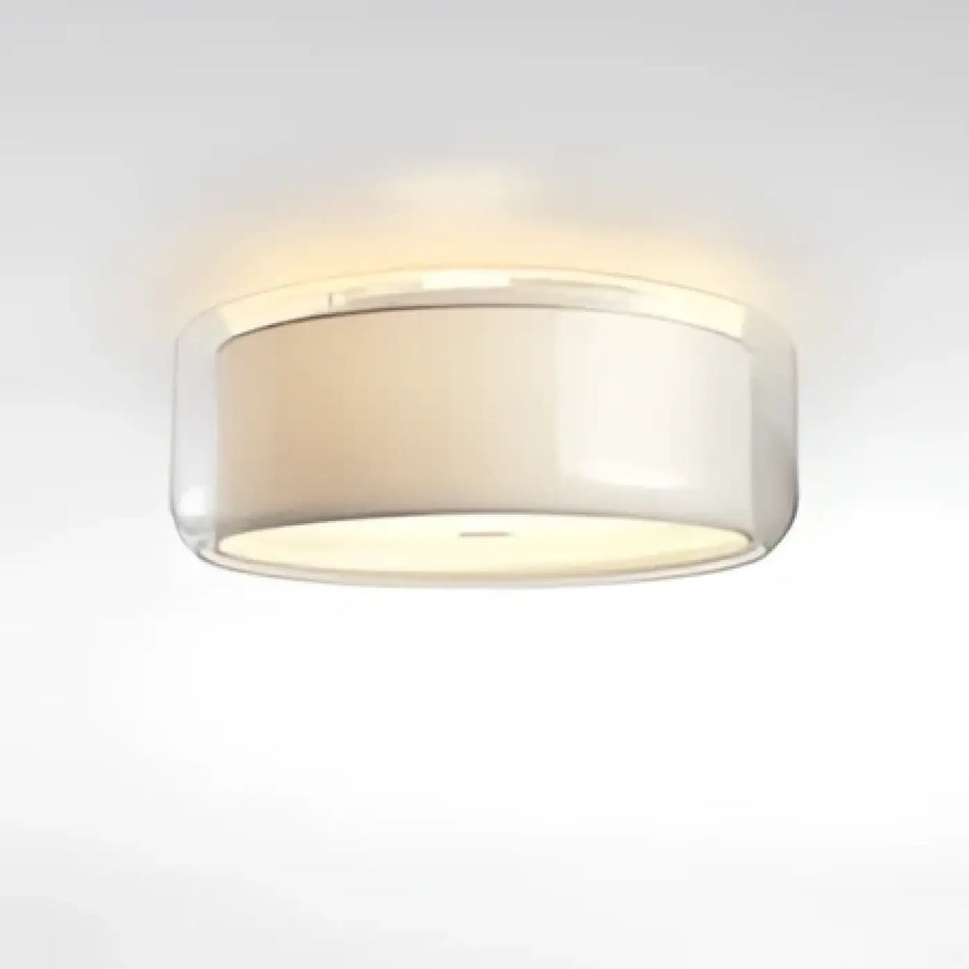 Luminaire plafonnier oreane avec abat-jour cylindrique en verre clair et diffuseur blanc givré contribuant à créer une ambiance chaleureuse