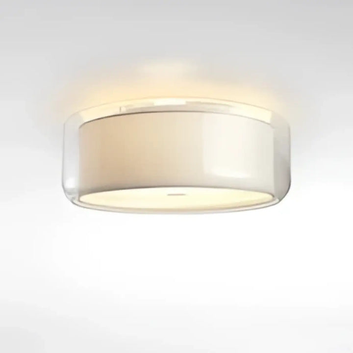 Luminaire plafonnier oreane avec abat-jour cylindrique en verre clair et diffuseur blanc givré contribuant à créer une ambiance chaleureuse