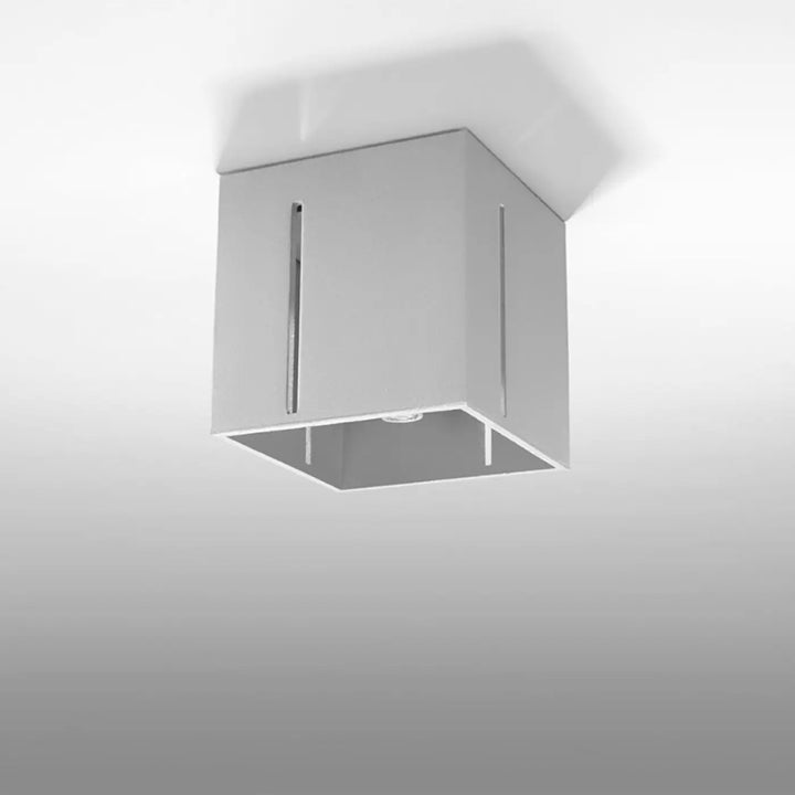 Luminaire plafonnier pixar gris avec finition métallique moderne et perforation linéaire pour un spectacle lumineux