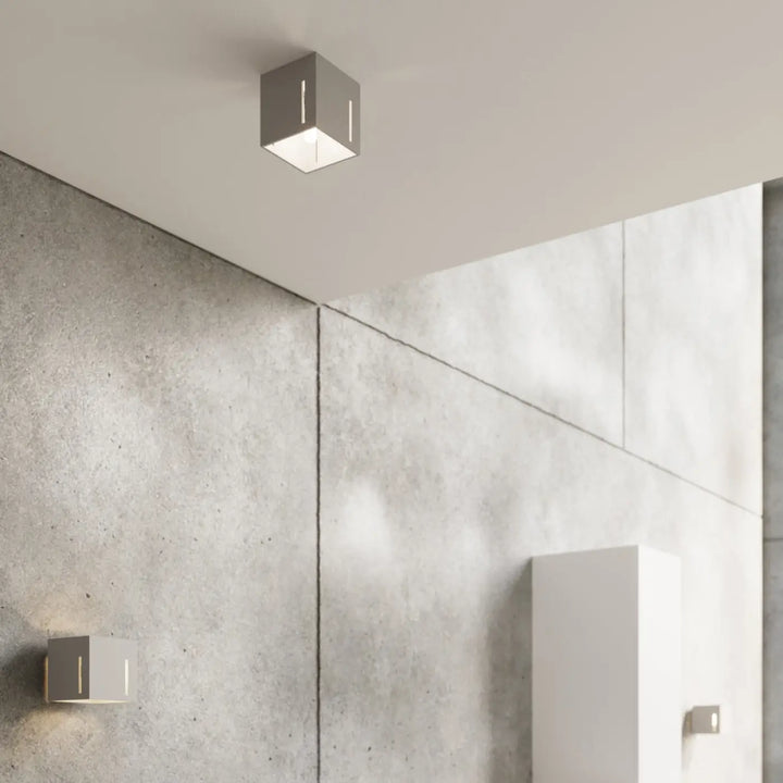 Luminaire plafonnier pixar gris avec perforation linéaire et design minimaliste pour un spectacle lumineux moderne