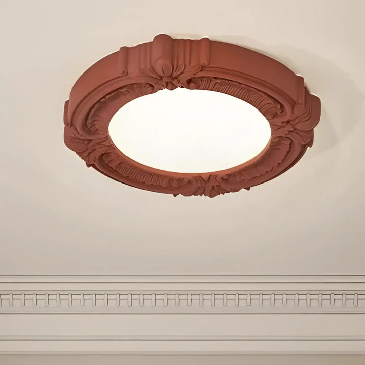 Luminaire plafonnier rosalia terracotta avec éclairage ornemental artistique à décor floral et volutes circulaires