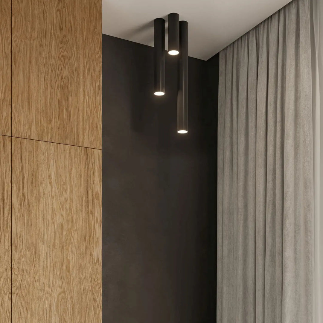 Trois luminaires plafonniers lagos 20 noirs cylindriques avec lumière fonctionnelle et élégance moderne chaleureuse