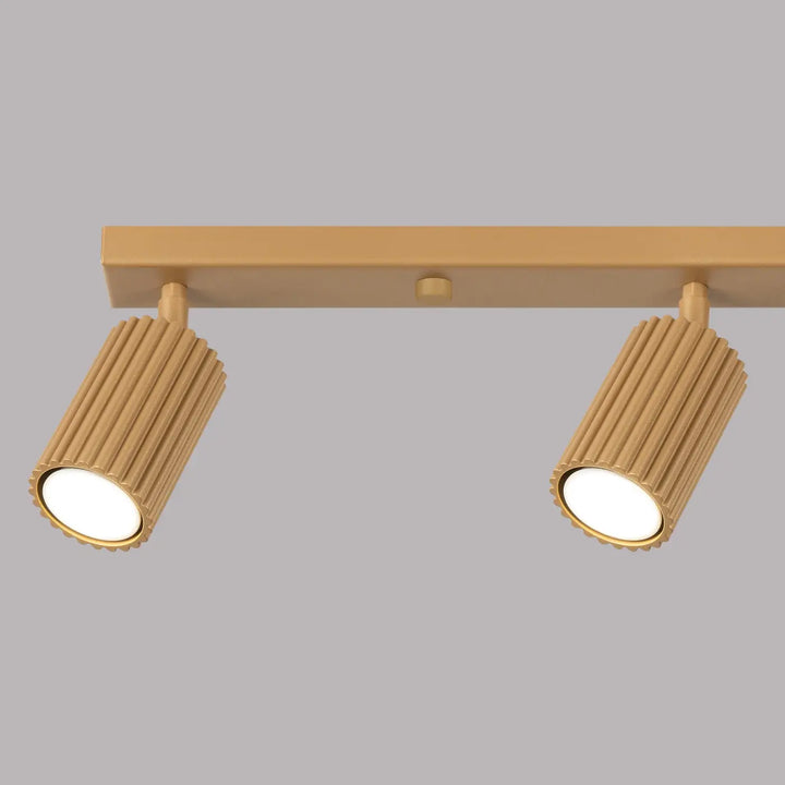 Plafonnier karbon allie double spot finition or avec têtes cylindriques cannelées et design minimaliste, ampoules gu10 interchangeables
