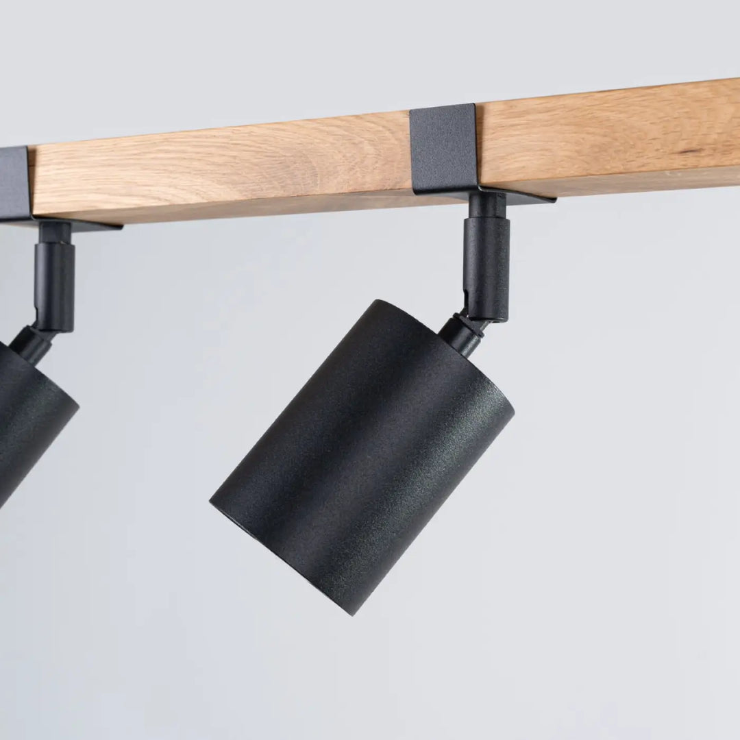 Luminaire plafonnier fager 3 noir avec boîtier moderne et abat-jours orientables monté sur poutre en bois