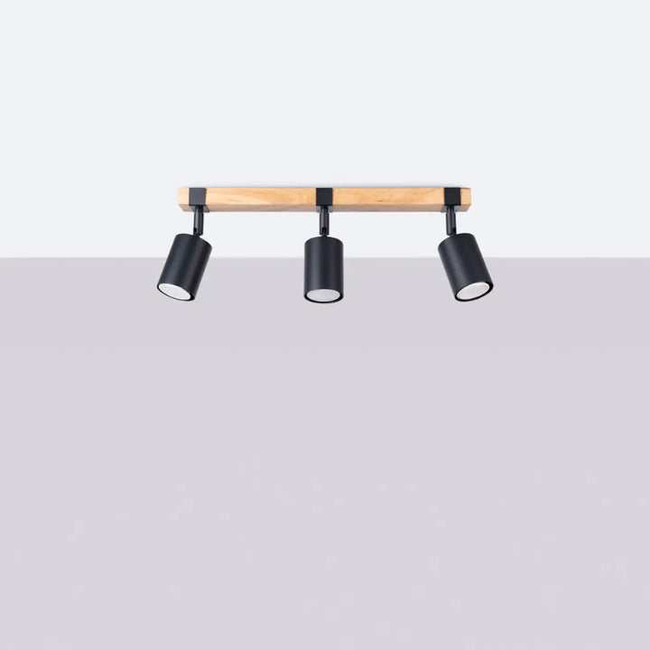 Lampe directionnelle fager 3 noir avec boîtier moderne et abat-jours orientables fixée sur une poutre en bois clair