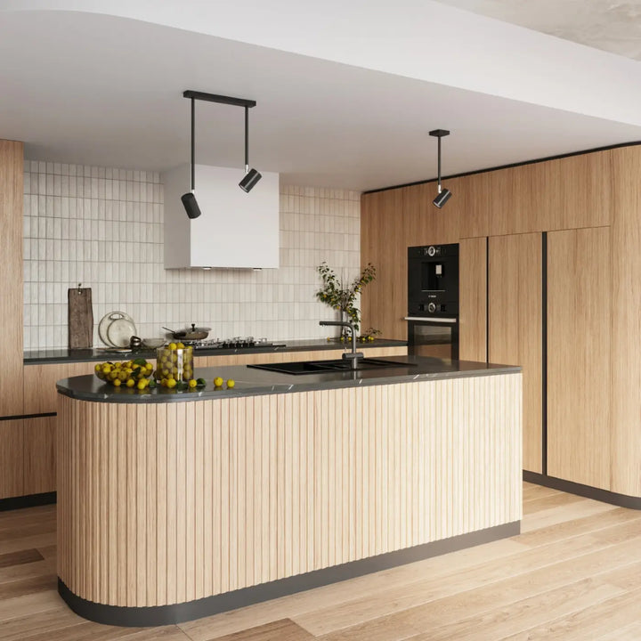Modern kitchen island with vertical wood slats and dark stone countertop in the plafonnier norano collection noir