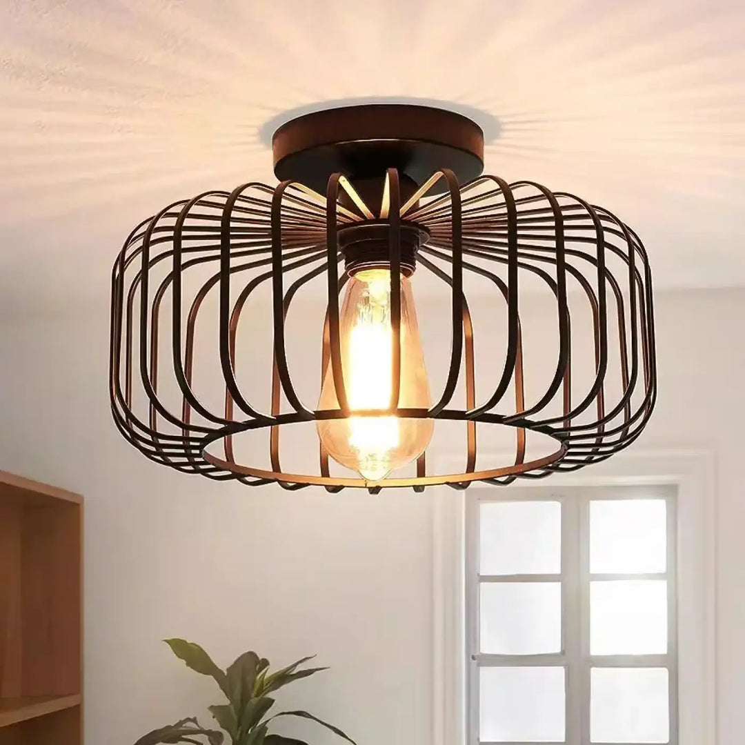Luminaire plafonnier style industriel en métal bronze foncé avec cage et ampoule edison pour une esthétique inspirée