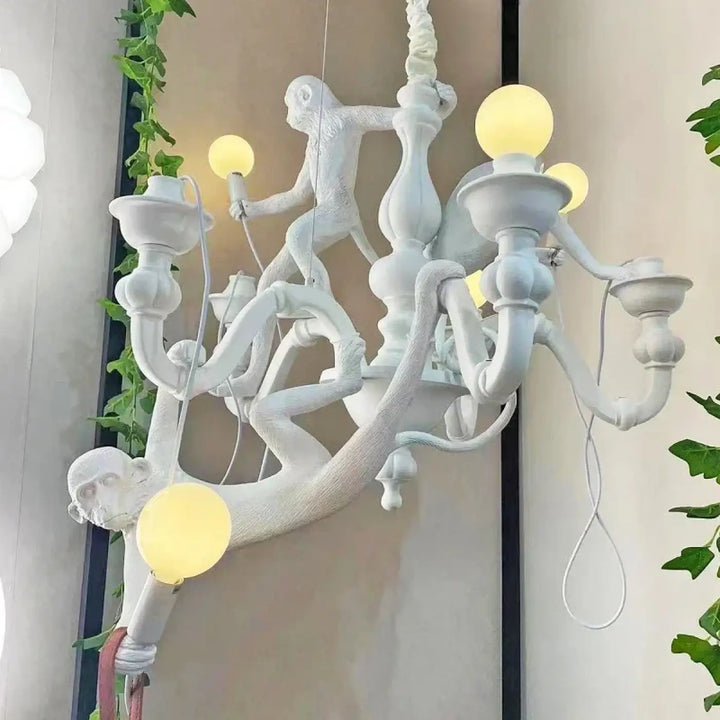 Lustre contemporaine blanc avec singes sculptés et luminaires globe jaune pour une allure animée et élégante